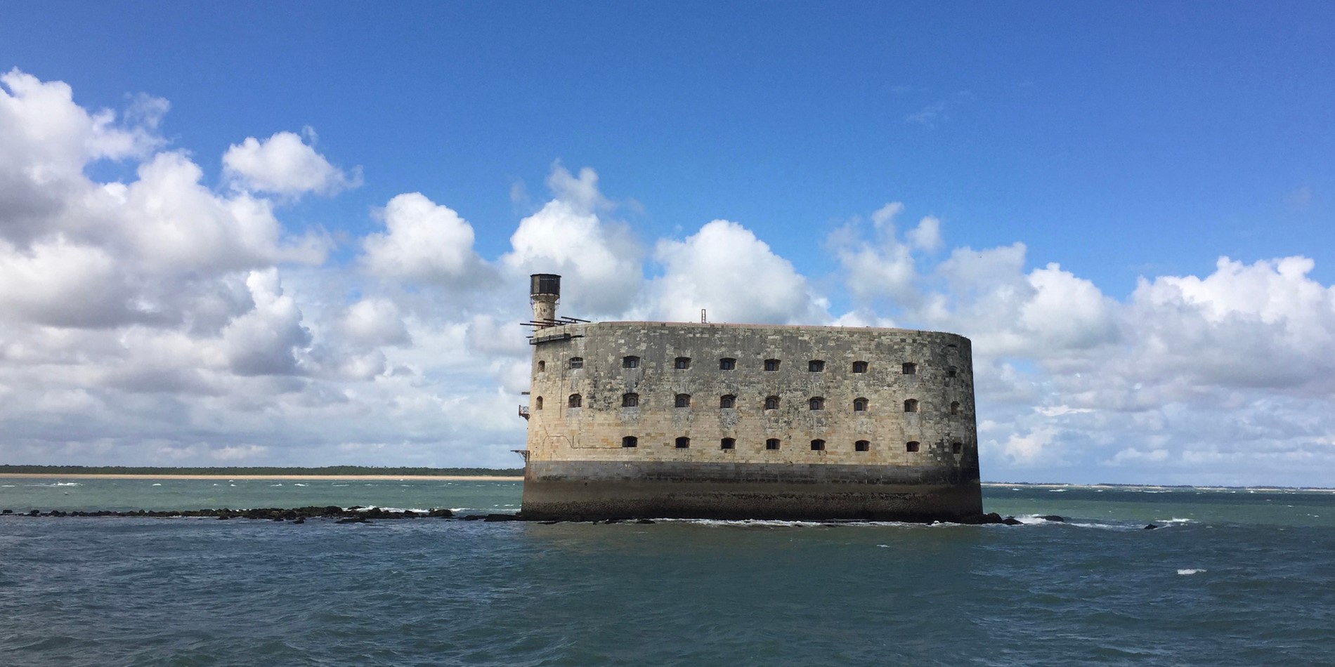 Fort Boyard, an ancient prison. A grey building / fort surrounded by water in Ile d'Aix, France.